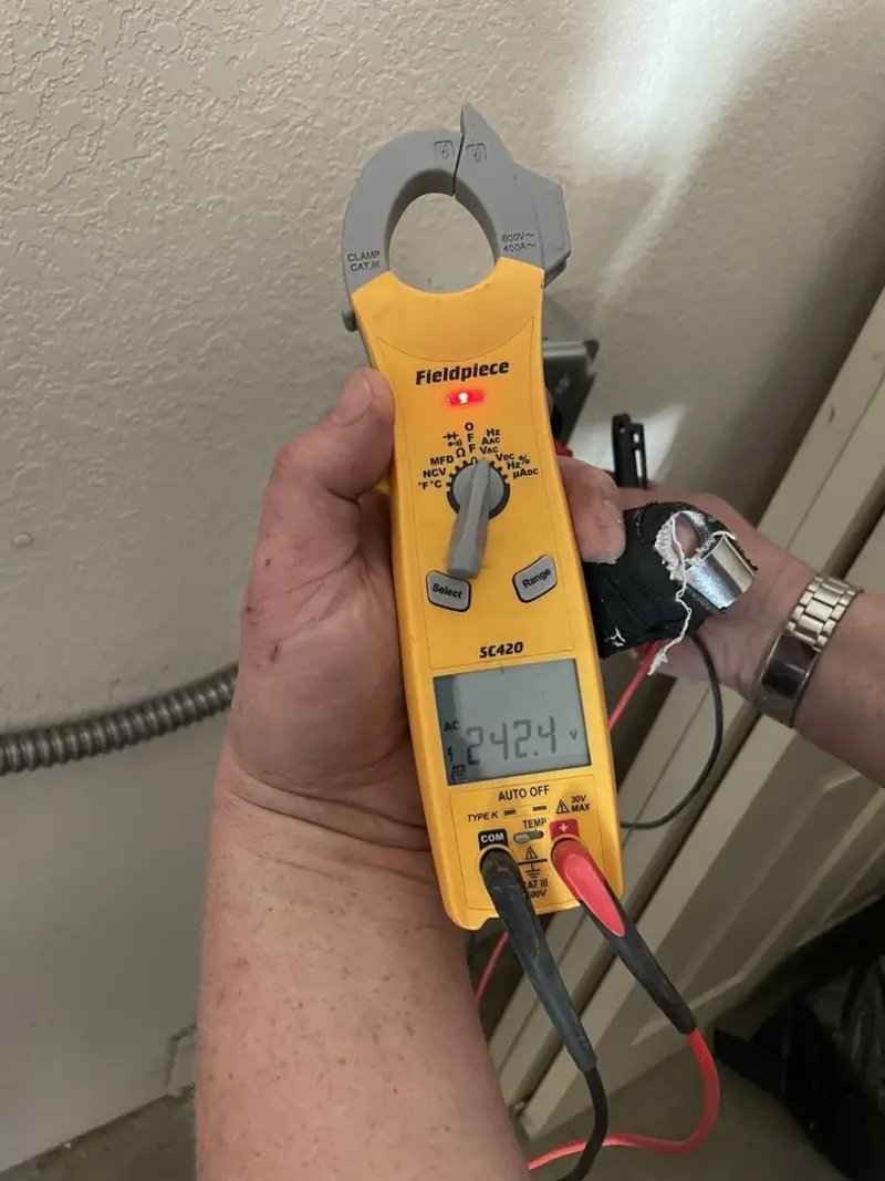 Voltage testing with clamp meter during Ceiling Fan Installation in Greenburgh